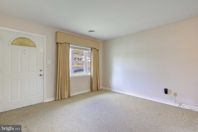 7203 Roanne Dr, Oxon Hill, MD 20745 - entrance foyer with light colored carpet, baseboards, and visible vents