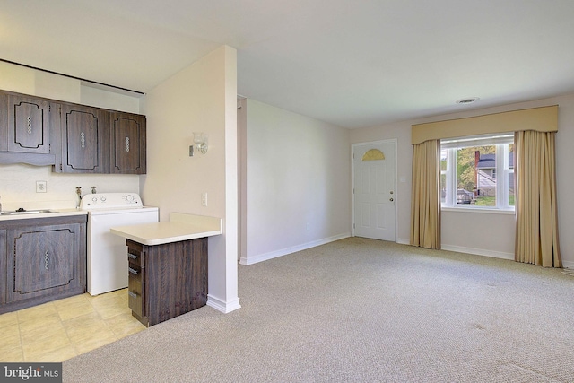 7203 Roanne Dr, Oxon Hill, MD 20745 - laundry room with washer / clothes dryer, light colored carpet, baseboards, and cabinet space