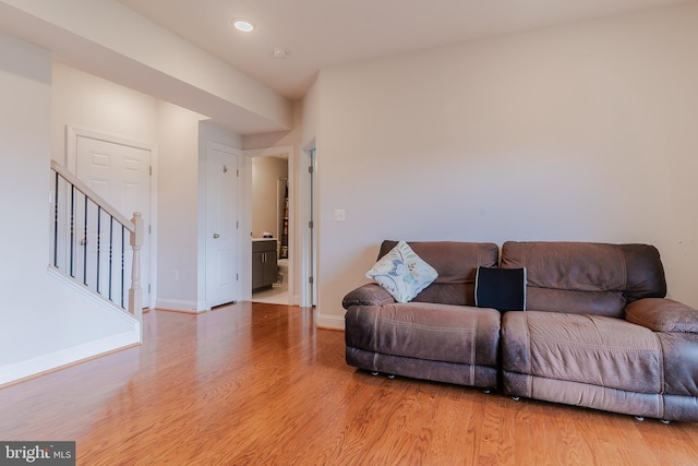 15332 Ballerina Loop, Woodbridge, VA 22193 - living room featuring light wood-style floors, stairs, and baseboards