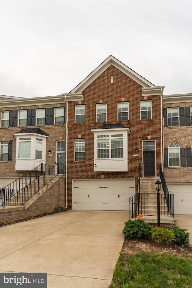 15332 Ballerina Loop, Woodbridge, VA 22193 - multi unit property featuring a garage, brick siding, and concrete driveway