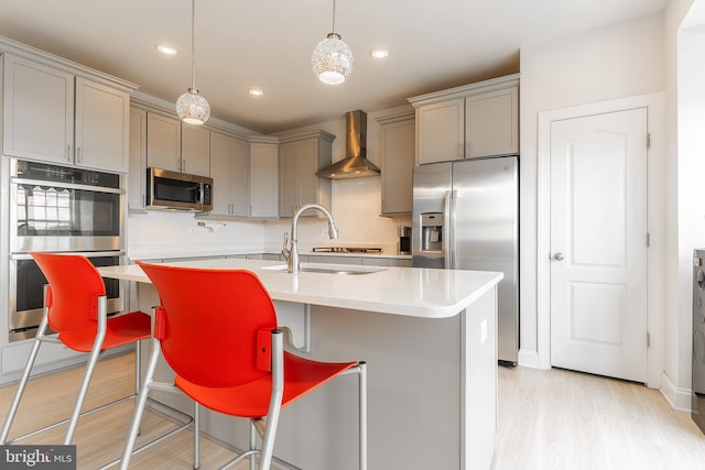 15332 Ballerina Loop, Woodbridge, VA 22193 - kitchen with wall chimney range hood, gray cabinetry, appliances with stainless steel finishes, a sink, and recessed lighting