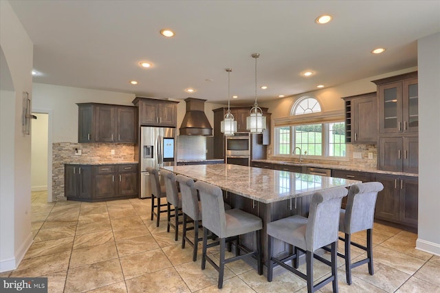 121 Rich Valley Rd, Mechanicsburg, PA 17050 - kitchen with decorative backsplash, dark brown cabinets, a sink, premium range hood, and stainless steel appliances