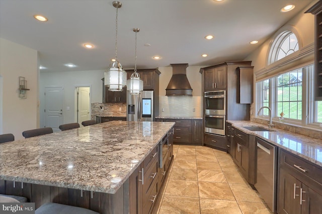 121 Rich Valley Rd, Mechanicsburg, PA 17050 - kitchen with custom range hood, a sink, appliances with stainless steel finishes, and a breakfast bar