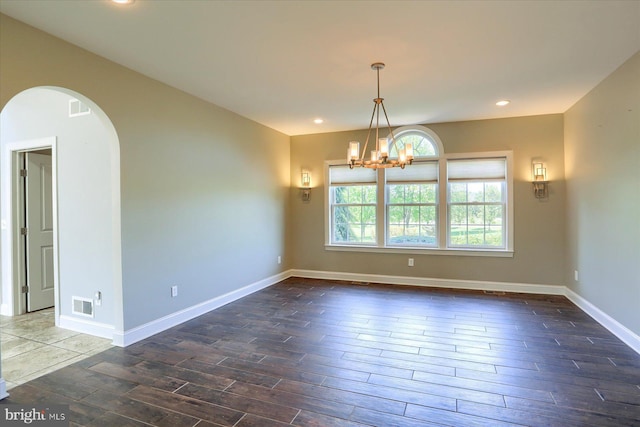 121 Rich Valley Rd, Mechanicsburg, PA 17050 - empty room with arched walkways, a notable chandelier, visible vents, and wood finished floors
