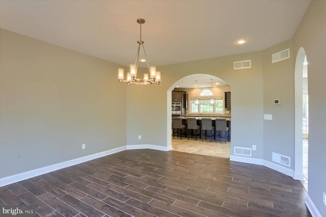 121 Rich Valley Rd, Mechanicsburg, PA 17050 - spare room featuring arched walkways, visible vents, and a chandelier