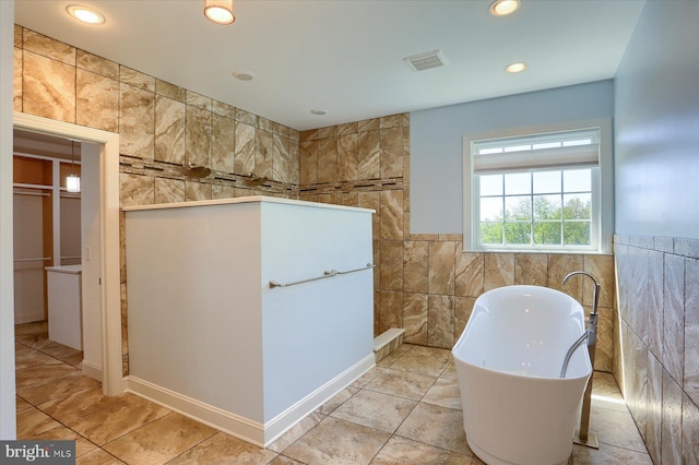 121 Rich Valley Rd, Mechanicsburg, PA 17050 - full bathroom featuring visible vents, tile walls, a walk in shower, a soaking tub, and recessed lighting