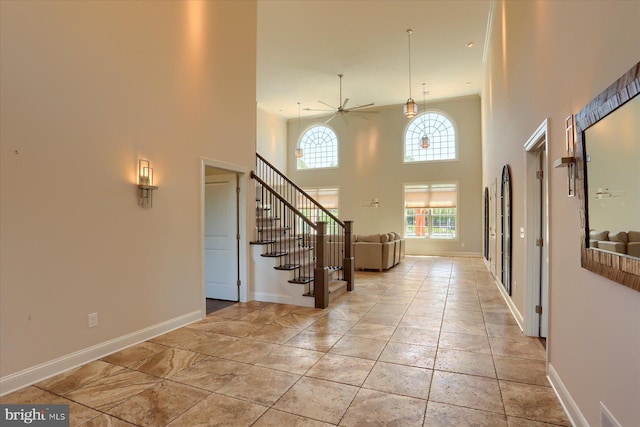 121 Rich Valley Rd, Mechanicsburg, PA 17050 - foyer featuring stairs, a ceiling fan, a high ceiling, and baseboards