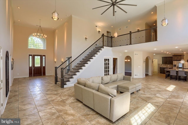 121 Rich Valley Rd, Mechanicsburg, PA 17050 - living area featuring stairway, arched walkways, ceiling fan, and a towering ceiling