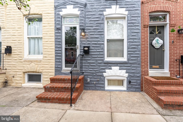 property entrance with stone siding