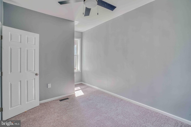 unfurnished bedroom with carpet flooring, baseboards, a ceiling fan, and visible vents