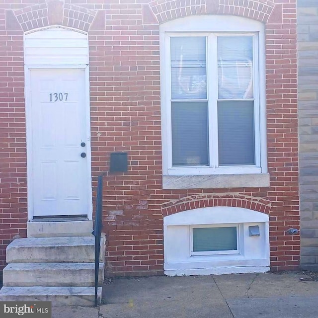 property entrance with brick siding