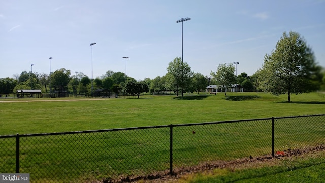 surrounding community featuring fence and a yard