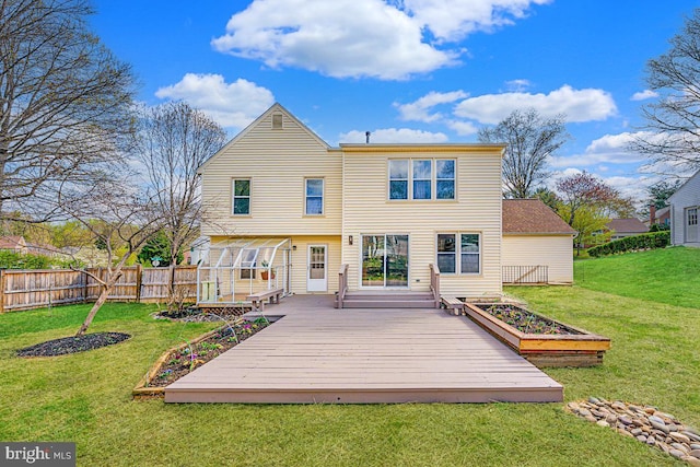 16012 Howard Landing Dr, Gaithersburg, MD 20878 - rear view of house featuring a garden, a wooden deck, fence, and a lawn