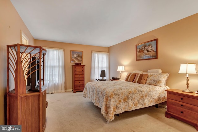 bedroom featuring light carpet