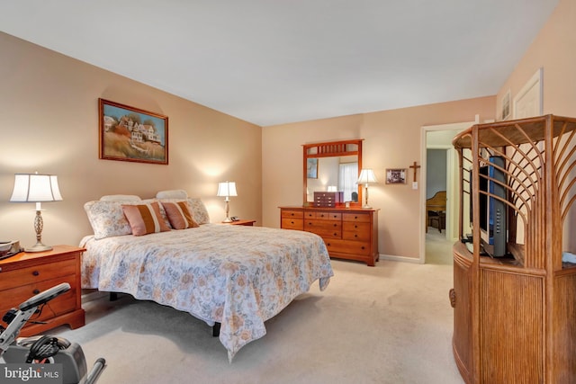 bedroom featuring light colored carpet and baseboards
