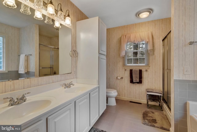 full bathroom featuring wallpapered walls, a sink, and a wealth of natural light
