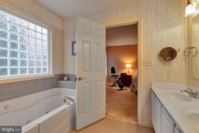 ensuite bathroom with a sink, wallpapered walls, and connected bathroom