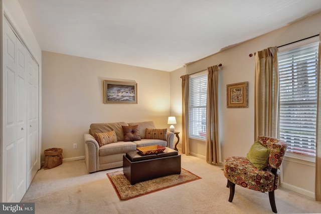 living room featuring baseboards and light carpet