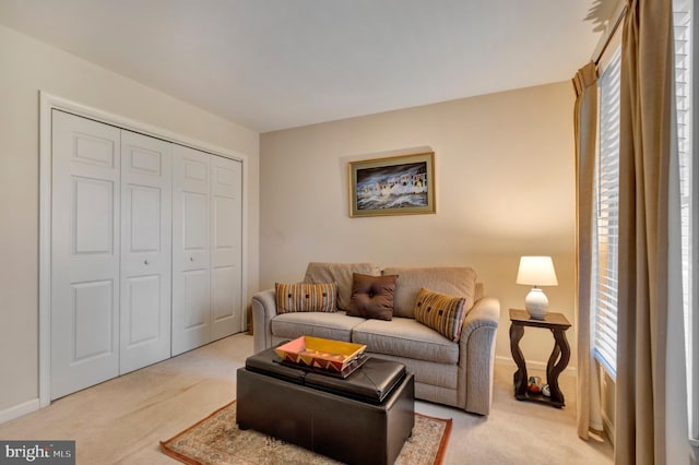 living room with baseboards and light colored carpet