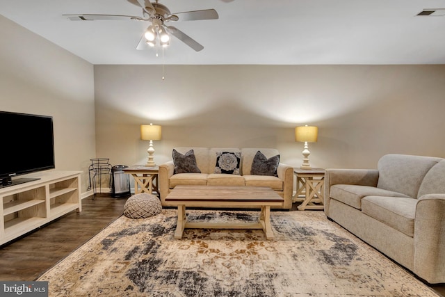 living area featuring dark wood-type flooring, ceiling fan, baseboards, and visible vents