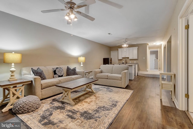 living area with hardwood / wood-style flooring, baseboards, and ceiling fan