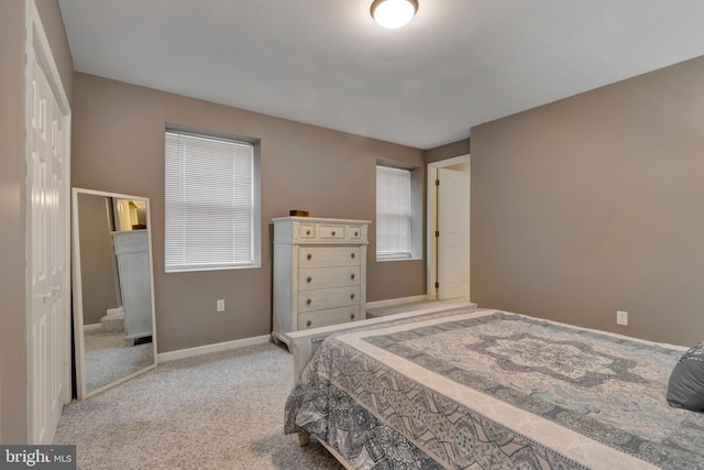 carpeted bedroom featuring baseboards
