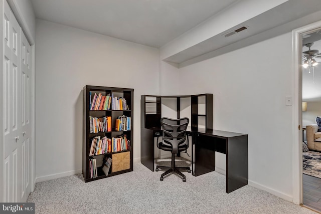 office featuring visible vents, baseboards, a ceiling fan, and carpet floors