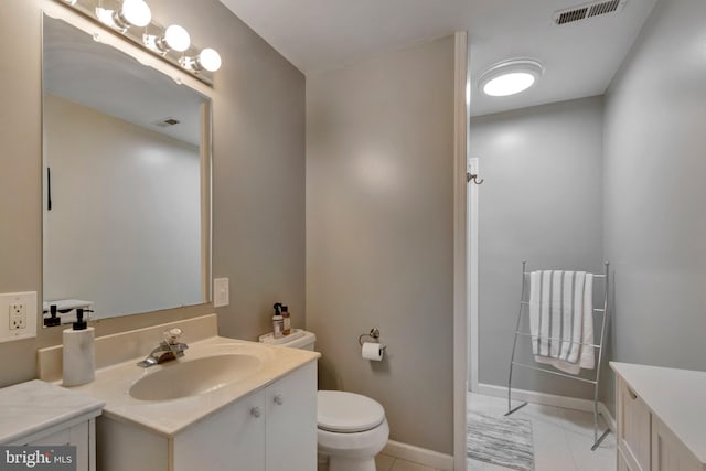 bathroom with visible vents, baseboards, toilet, vanity, and tile patterned flooring