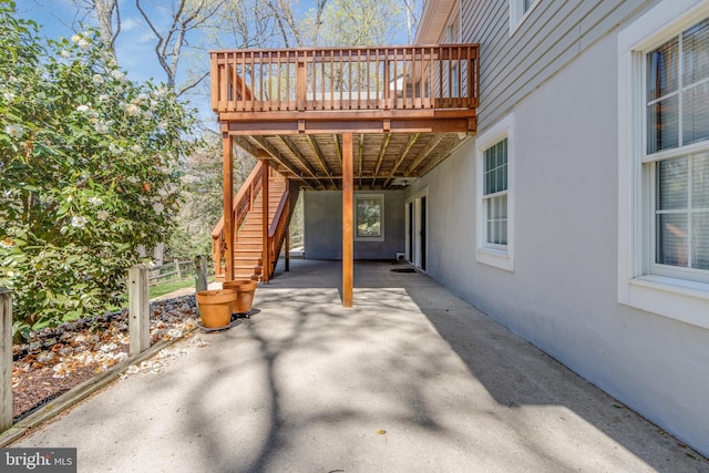 view of patio with a wooden deck and stairway