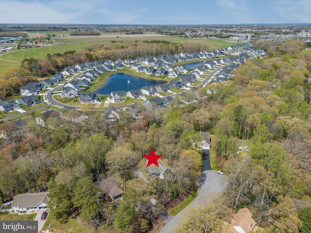 drone / aerial view with a water view and a residential view