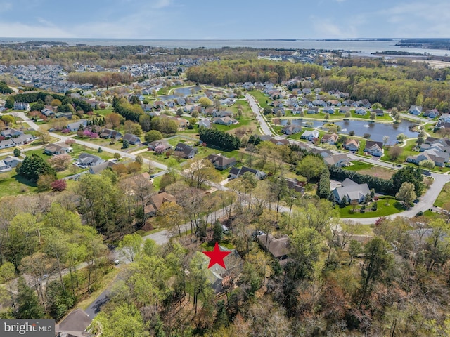 birds eye view of property with a residential view and a water view