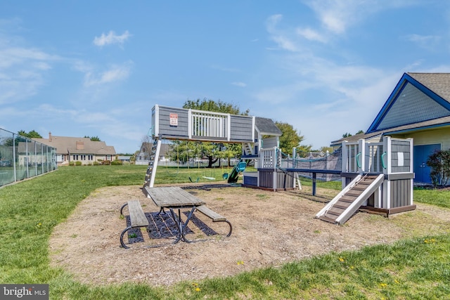 exterior space featuring fence and a playground