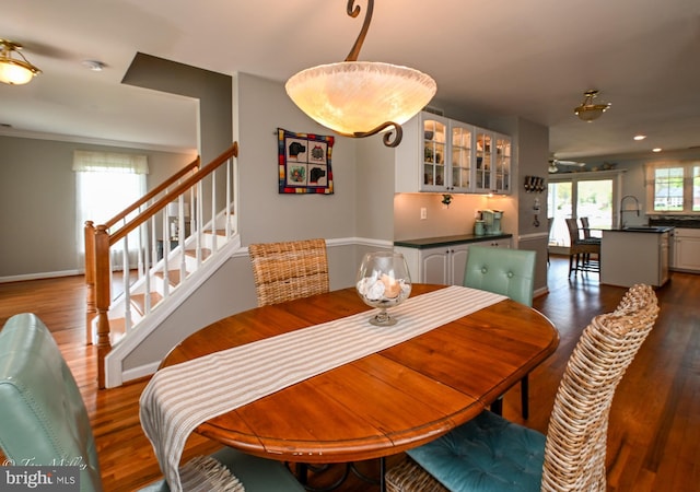 dining space featuring recessed lighting, stairway, dark wood-style flooring, and baseboards