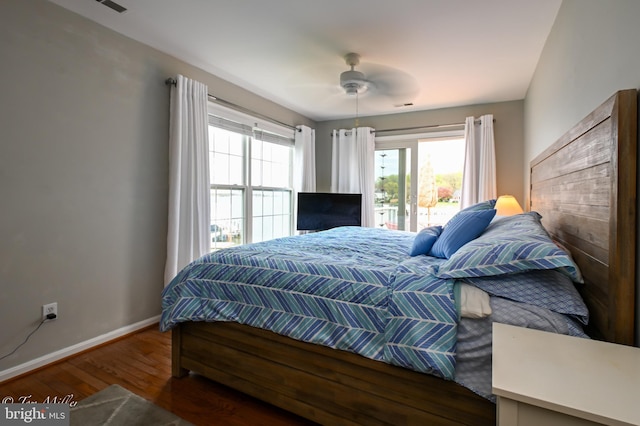 bedroom with wood finished floors, ceiling fan, and baseboards