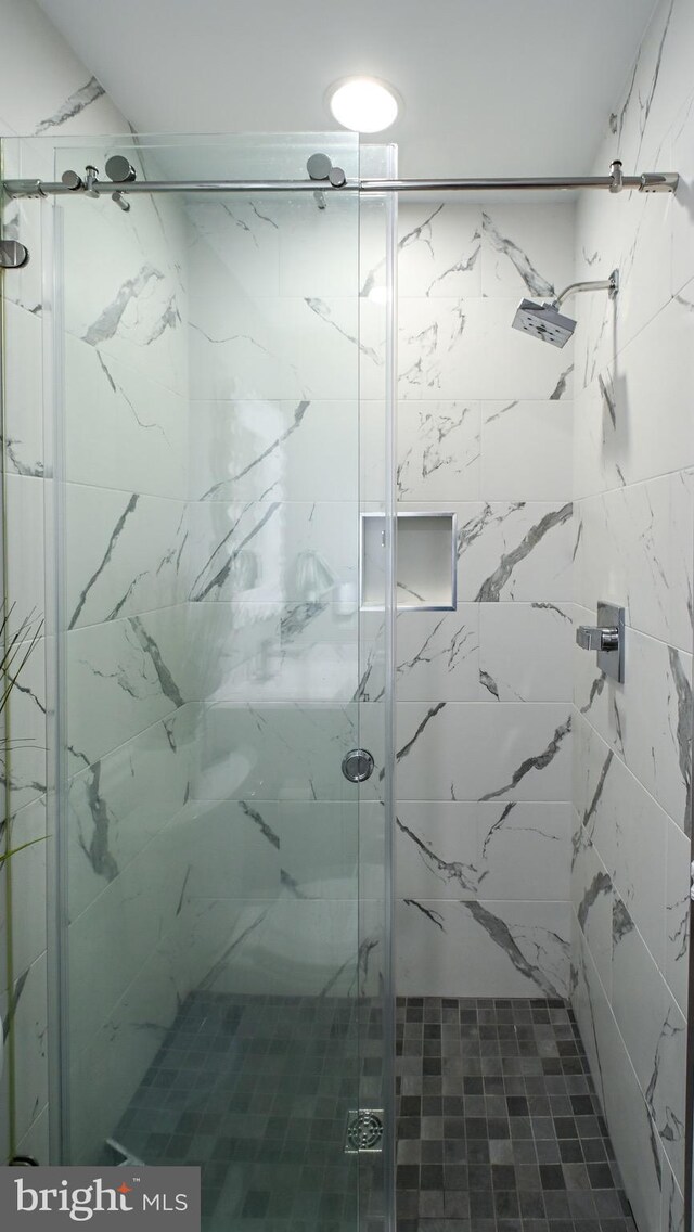 bathroom with a marble finish shower