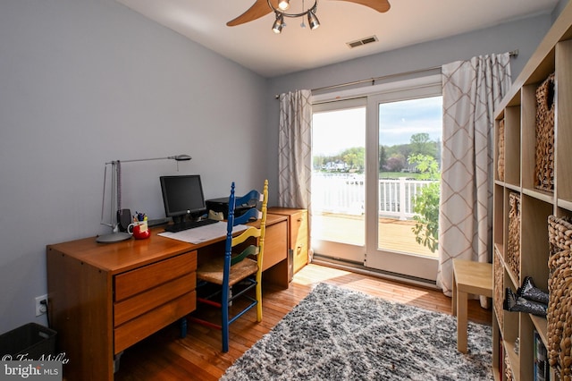 office area with visible vents, a ceiling fan, and wood finished floors