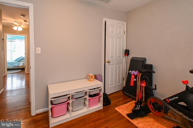 rec room featuring wood finished floors, ceiling fan, baseboards, and visible vents