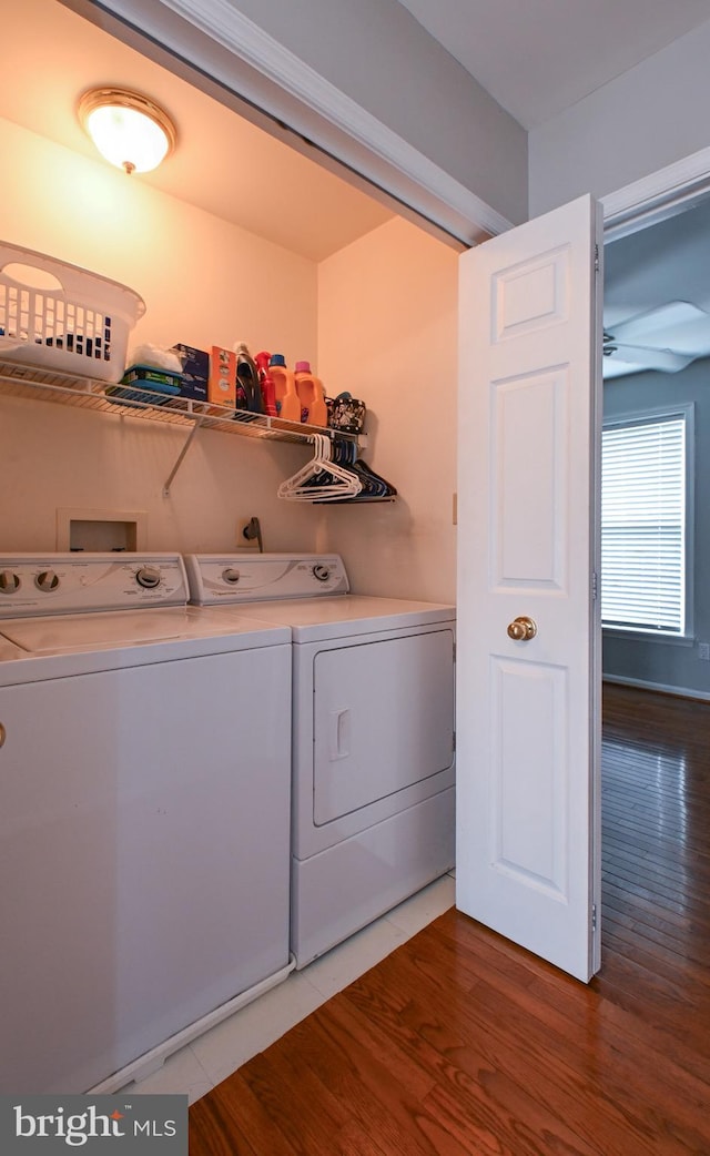 washroom featuring washer and dryer, ceiling fan, laundry area, and wood finished floors