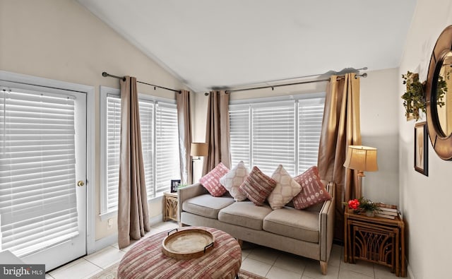living room featuring vaulted ceiling and light tile patterned floors