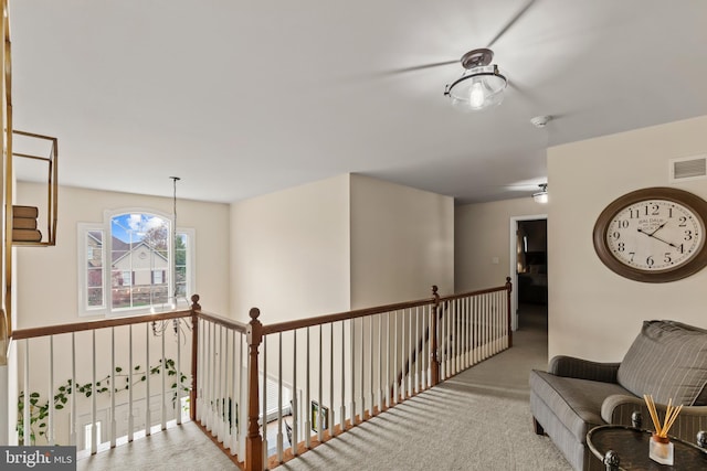 hallway featuring visible vents and carpet flooring