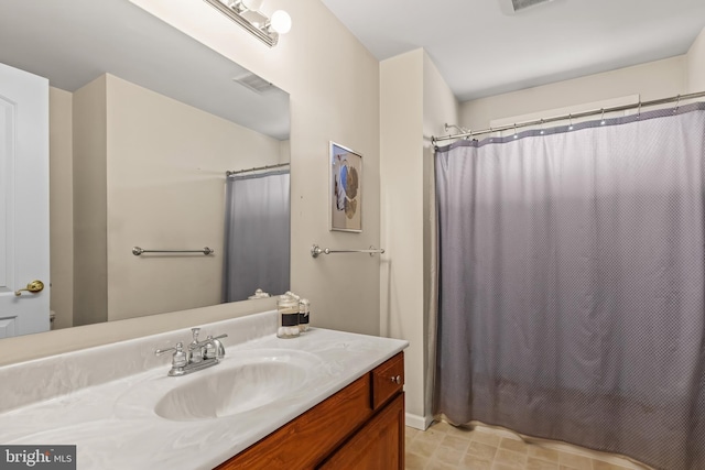 full bathroom with visible vents, vanity, and a shower with shower curtain