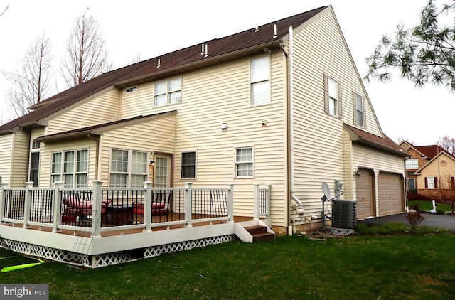 back of property with cooling unit, driveway, a garage, a lawn, and a deck