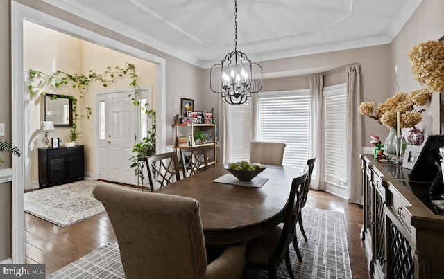 dining area featuring an inviting chandelier, dark wood-style flooring, and crown molding