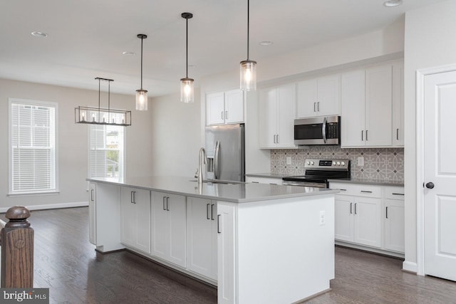 3393 Monterey Dr, Rockingham, VA 22801 - kitchen with an island with sink, dark wood-style floors, white cabinetry, stainless steel appliances, and backsplash
