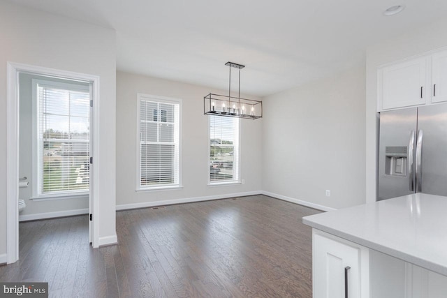 3393 Monterey Dr, Rockingham, VA 22801 - unfurnished dining area with baseboards, an inviting chandelier, and dark wood finished floors