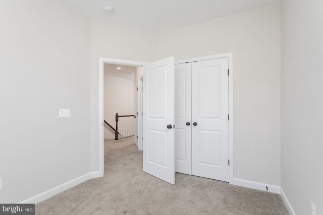 3393 Monterey Dr, Rockingham, VA 22801 - unfurnished bedroom with a closet, light colored carpet, and baseboards