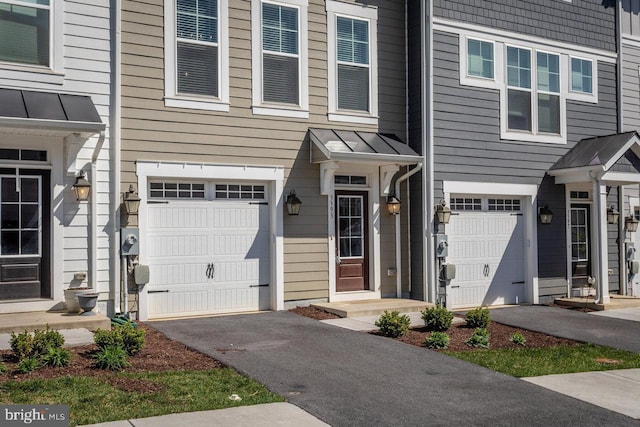 3393 Monterey Dr, Rockingham, VA 22801 - view of front of home with a standing seam roof, a garage, driveway, and metal roof