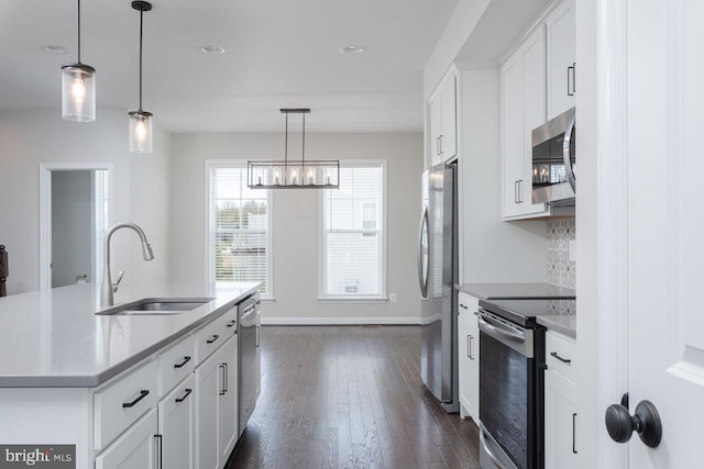 3393 Monterey Dr, Rockingham, VA 22801 - kitchen featuring baseboards, white cabinets, a sink, appliances with stainless steel finishes, and dark wood finished floors