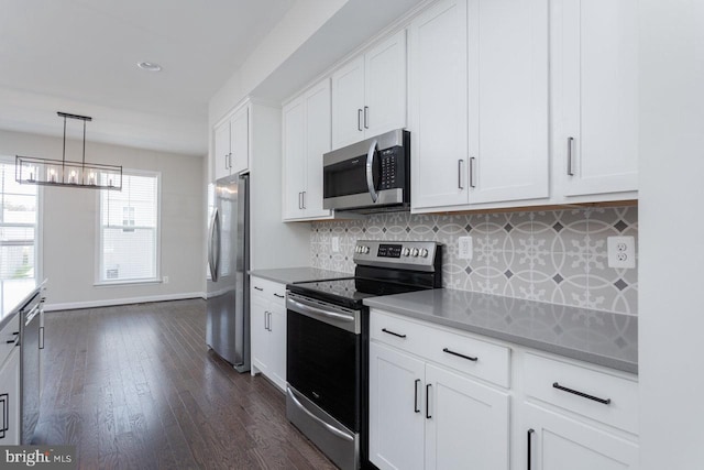 3393 Monterey Dr, Rockingham, VA 22801 - kitchen featuring dark wood finished floors, tasteful backsplash, white cabinetry, appliances with stainless steel finishes, and a notable chandelier