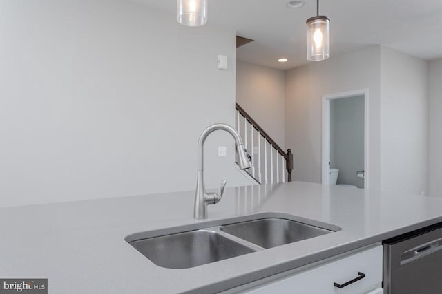 3393 Monterey Dr, Rockingham, VA 22801 - kitchen featuring a sink, stainless steel dishwasher, decorative light fixtures, and white cabinets